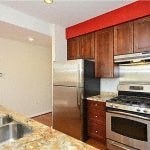 a kitchen with stainless steel appliances and wooden cabinets