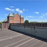 a bridge with a brick building in the background