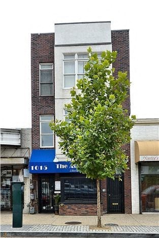 a building on the side of a street with a tree