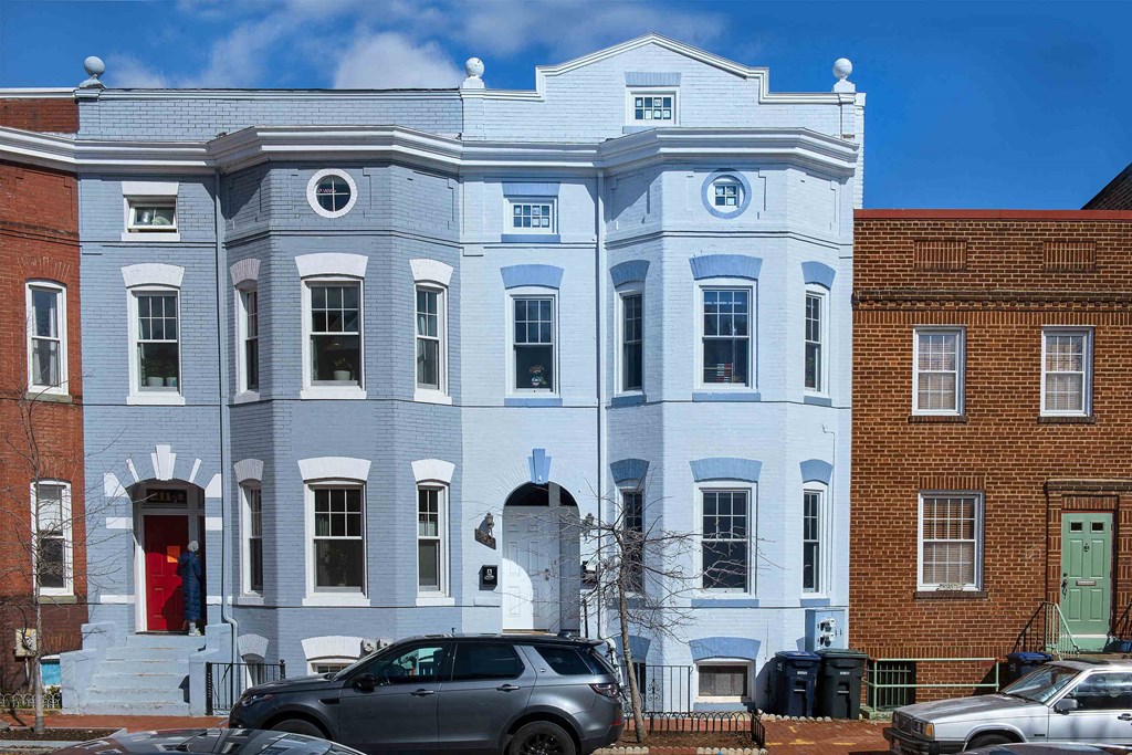 a blue and white building on a city street