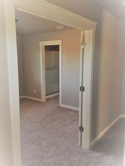 a view of the hallway from the living room into the bathroom