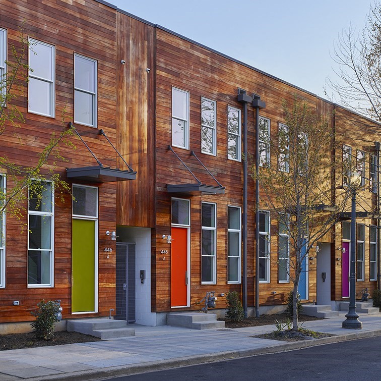 a row of houses with colorful doors on a street
