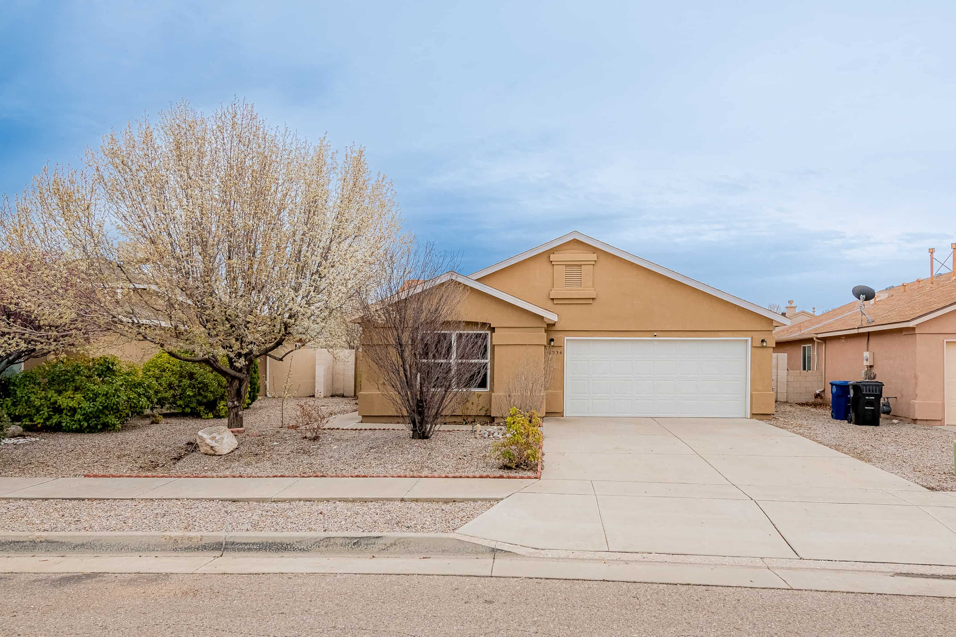 a beige house with a white garage door