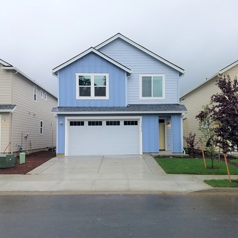 a blue house with a white garage door