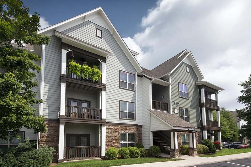 a large apartment building with balconies and trees