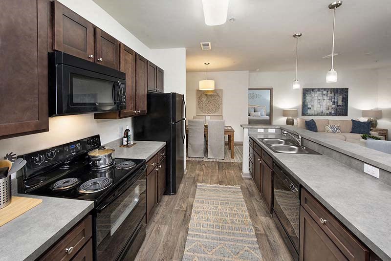 a large kitchen with a stove and a microwave