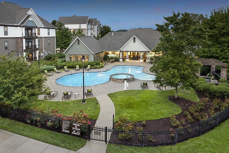 an aerial view of a swimming pool and a house