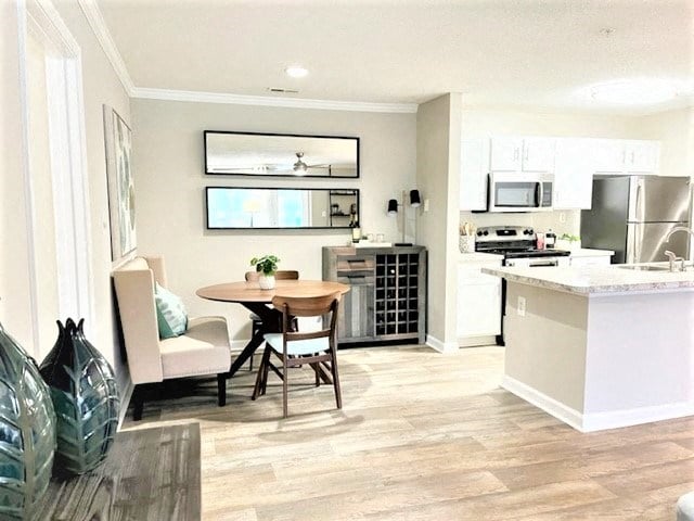 a kitchen and living room with a table and chairs