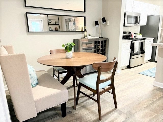 a kitchen and dining room with a table and chairs