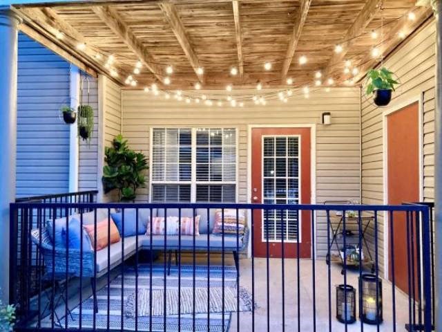a porch with a couch and lights on it