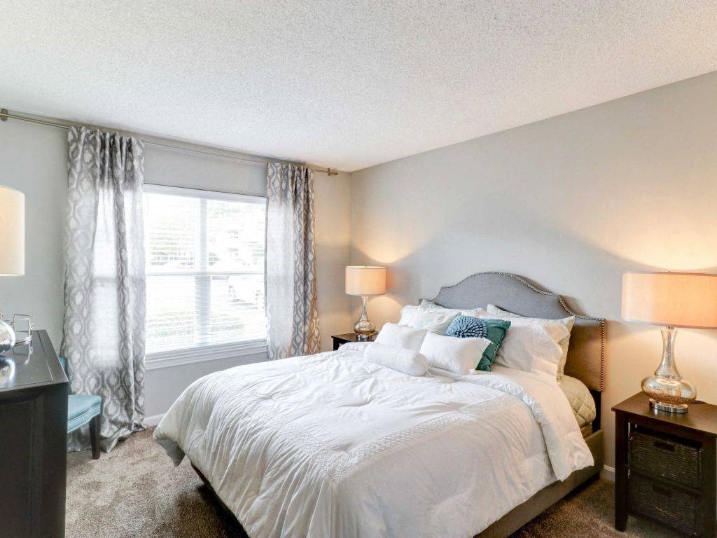 a bedroom with a bed and a window