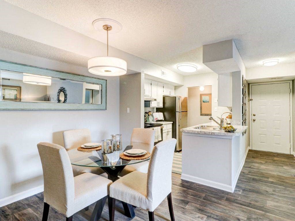 a dining room and kitchen with a table and chairs
