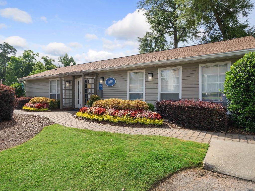 a house with a yard and a sidewalk in front of it