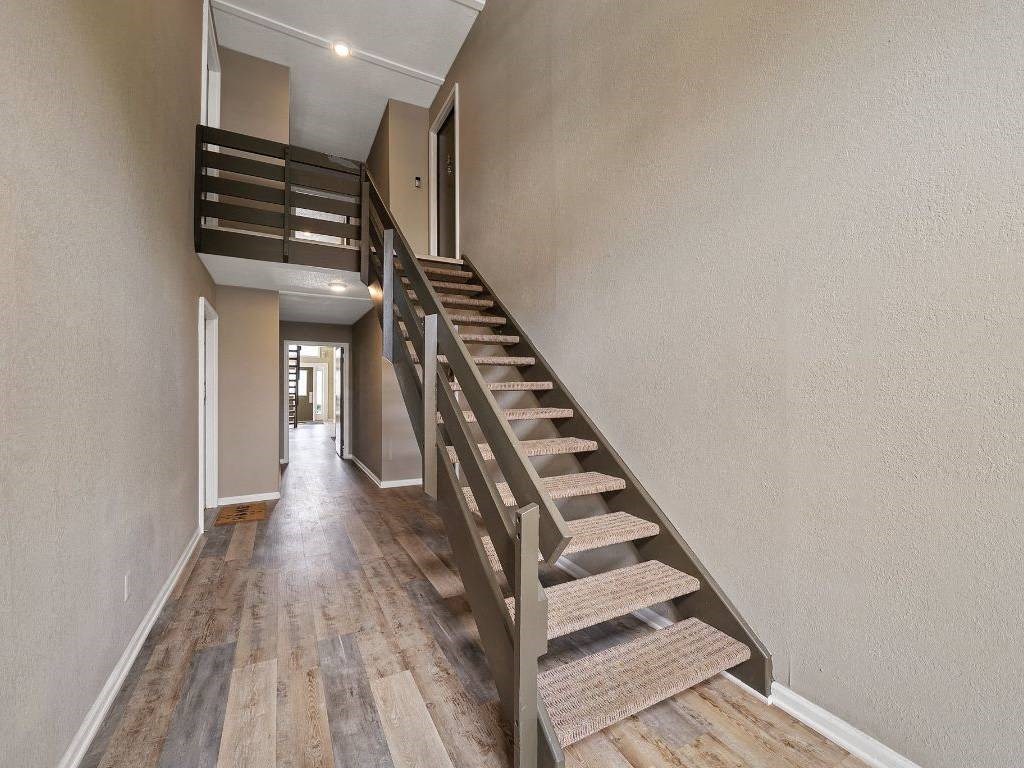 the landing of a staircase in a house with wood floors