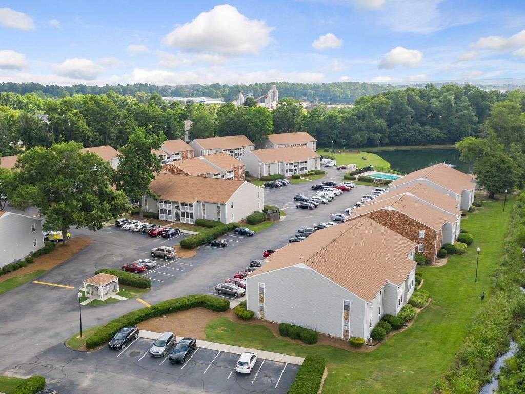 an aerial view of an apartment building and parking lot