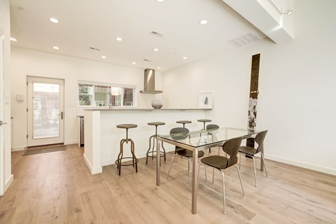 A kitchen with a table and chairs.