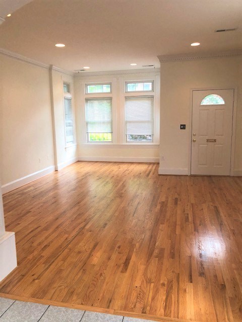 an empty living room with a hard wood floor
