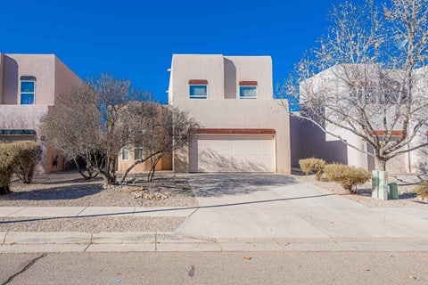 a white house with a driveway and a garage door