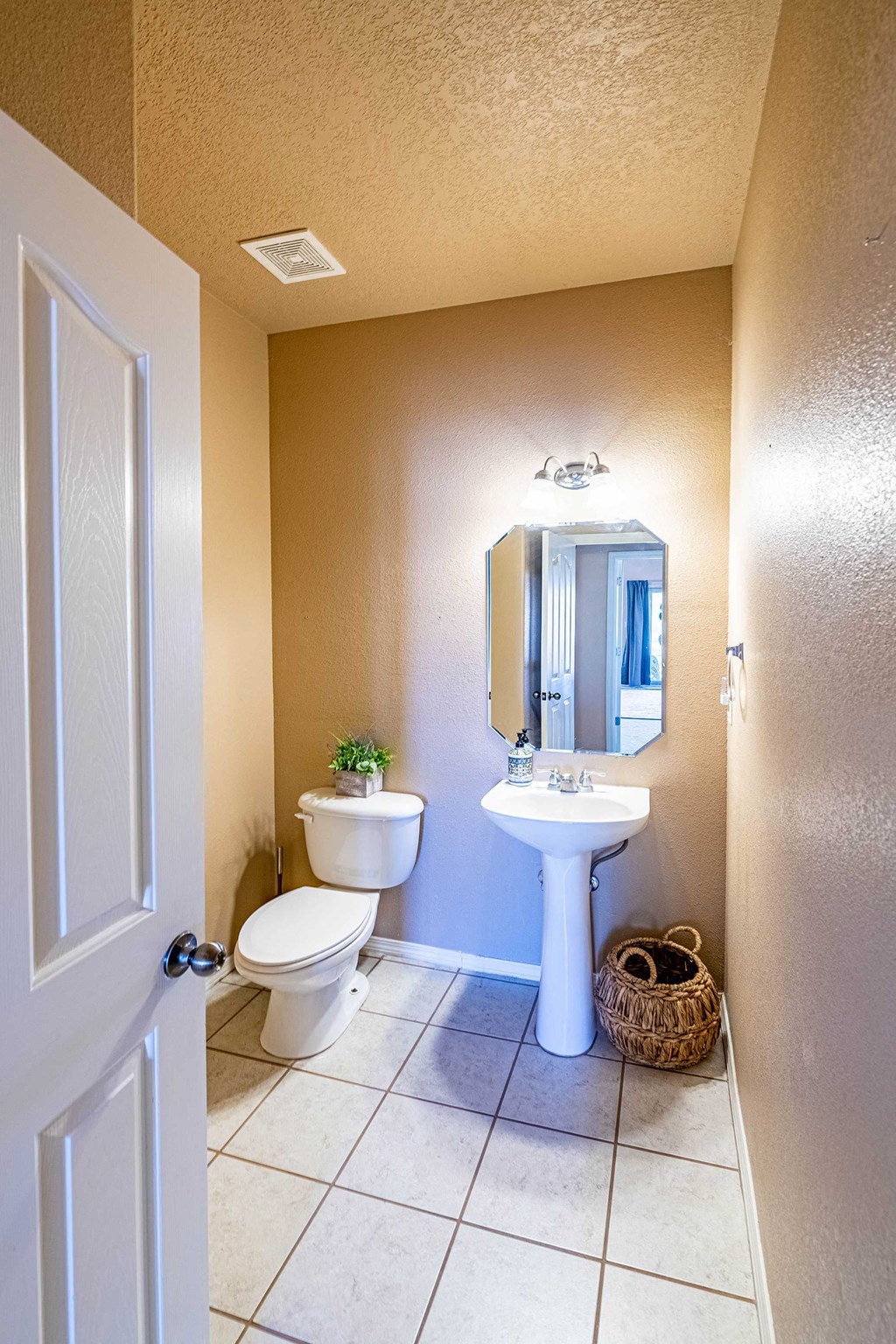 a bathroom with a toilet sink and a mirror