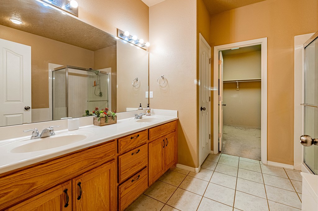 a bathroom with two sinks and a large mirror
