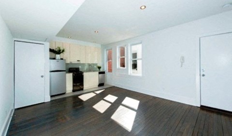 a large living room with a kitchen in it