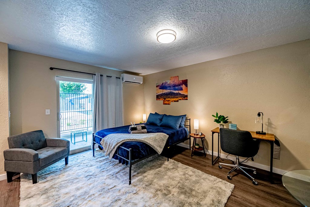 a bedroom with a bed and a desk with a chair