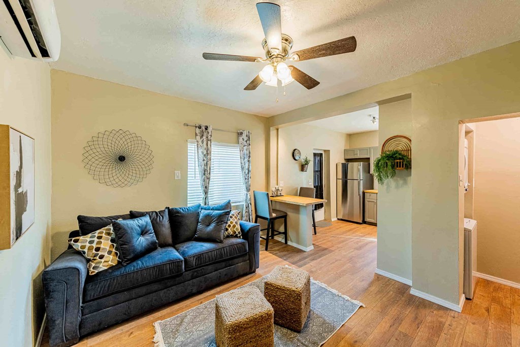 a living room with a couch and a ceiling fan