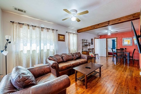 a living room with leather couches and a coffee table