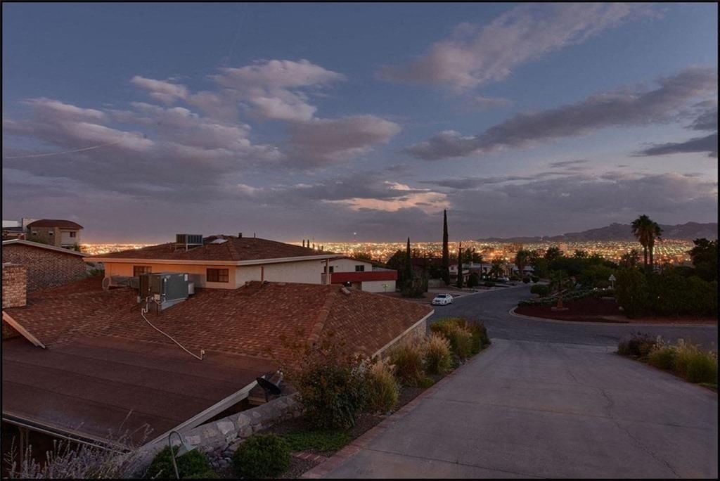 the city at night with roofs and a road