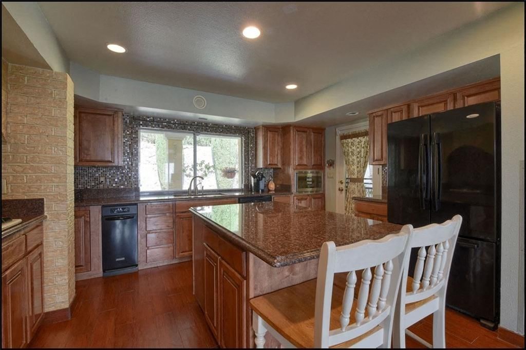 a large kitchen with a granite counter top