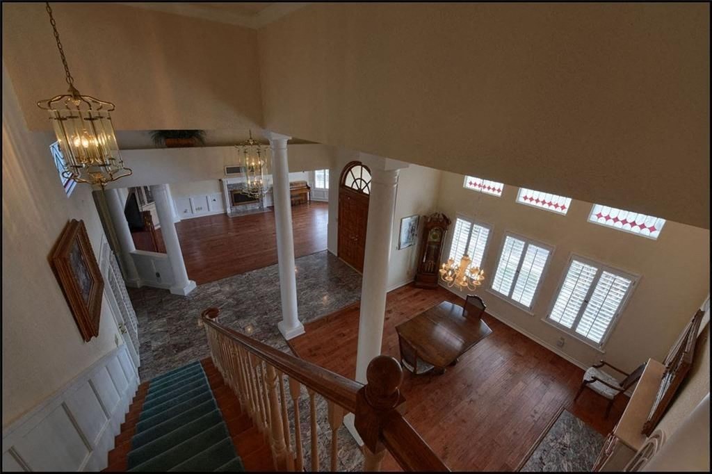 the view of a living room from the top of a staircase