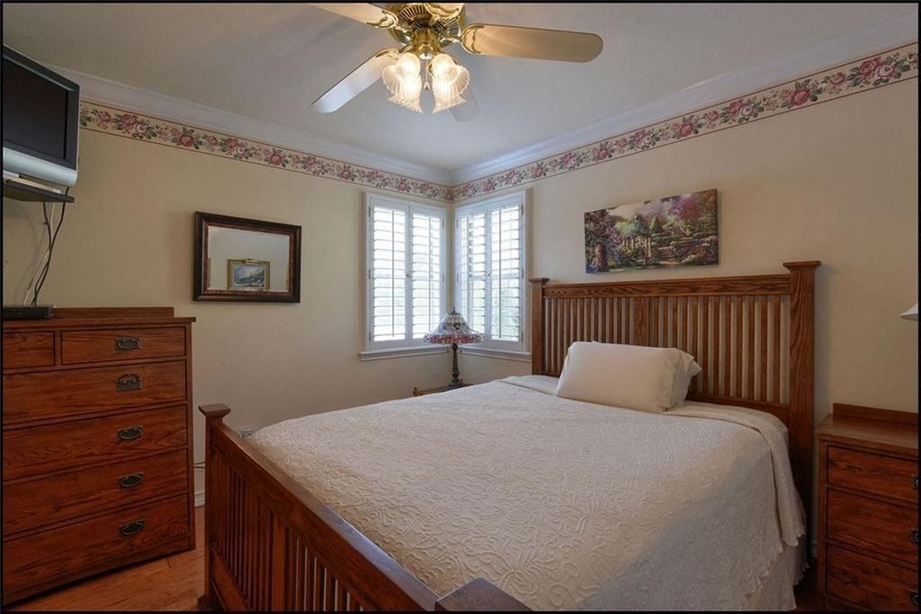 a bedroom with a bed and a ceiling fan