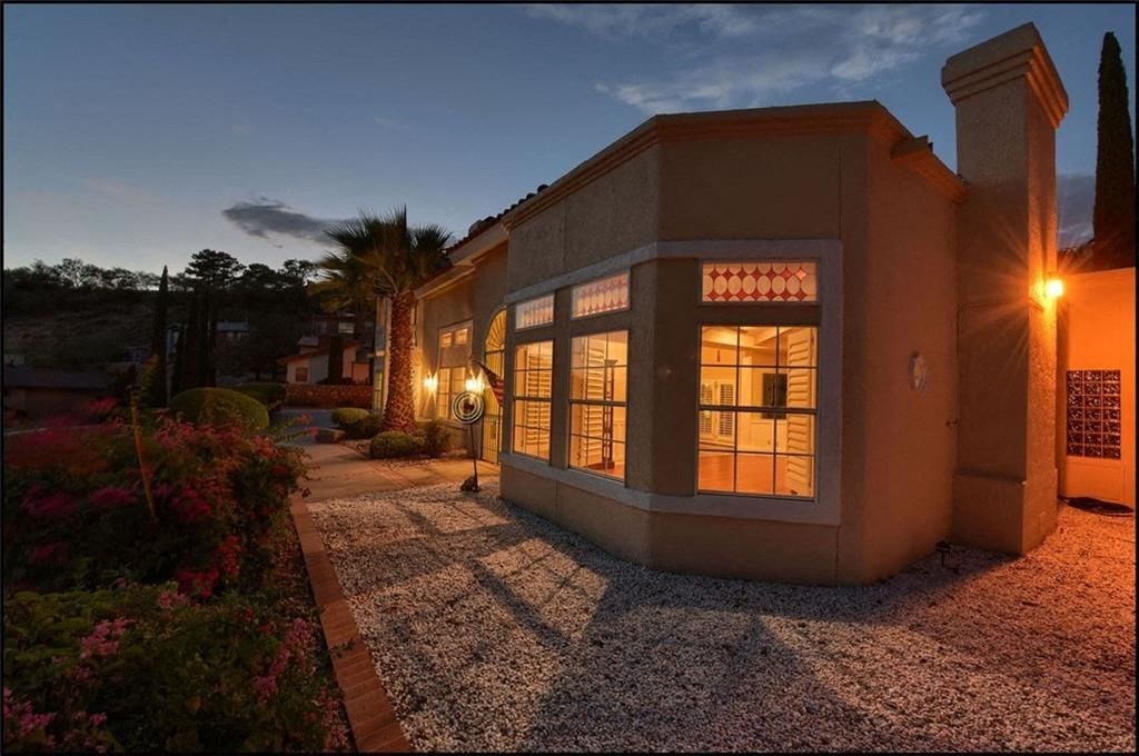 the house is lit up at night with the lights on in the window