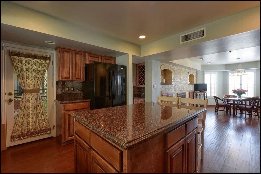 a large kitchen with a granite counter top
