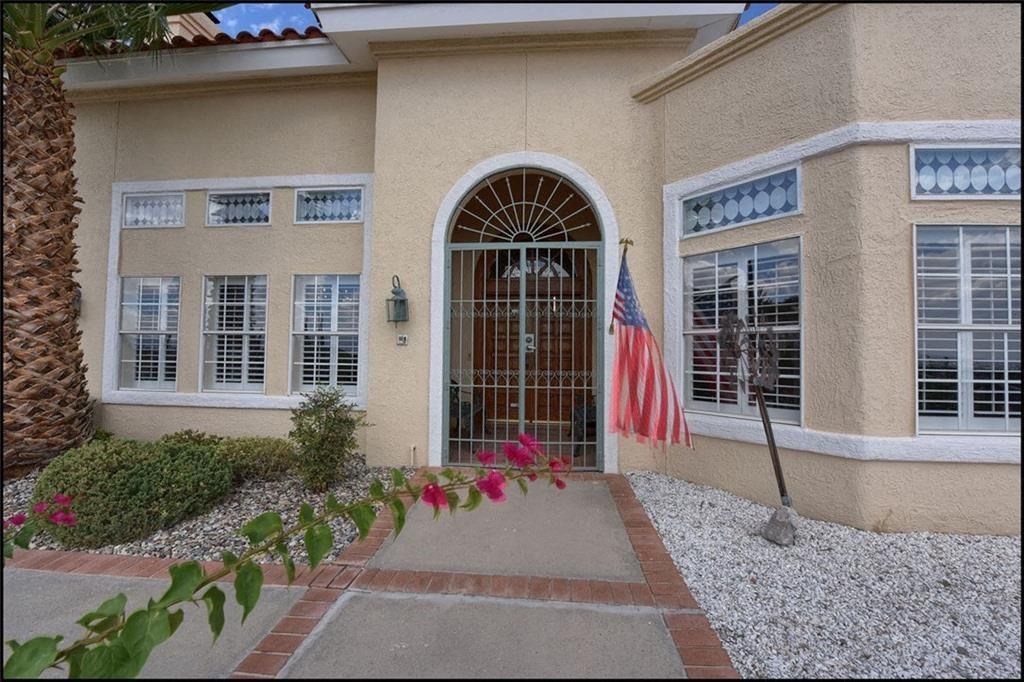 a house with an flag in front of a gate