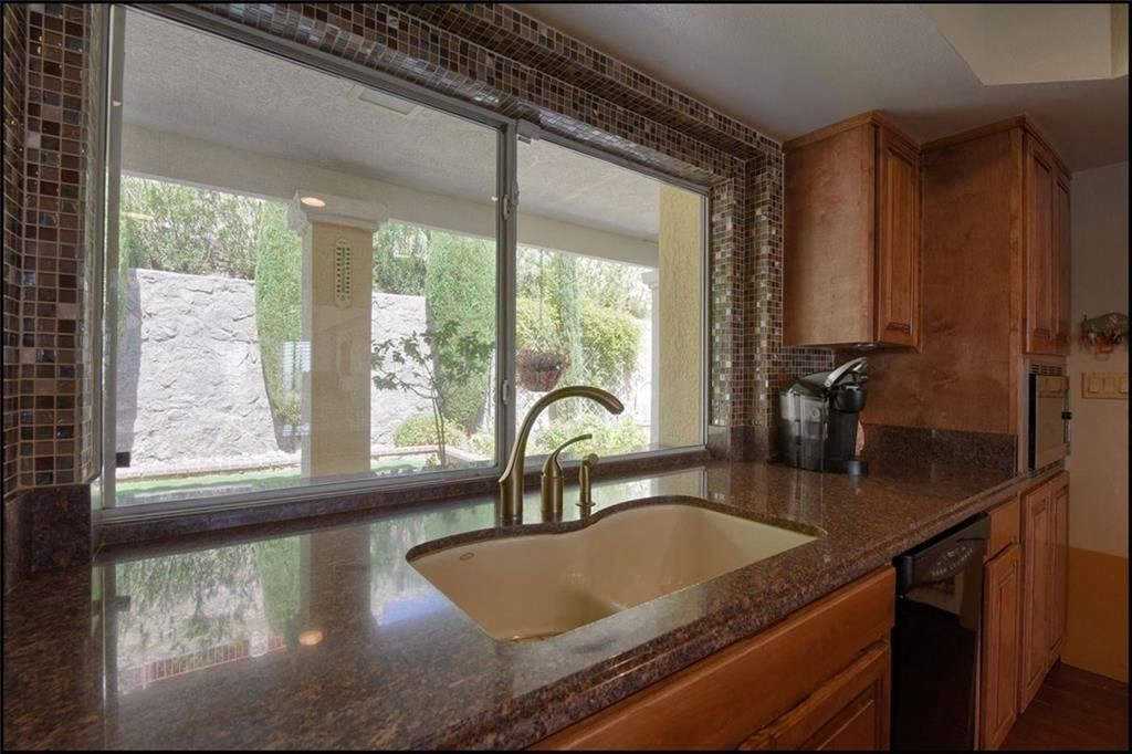 a kitchen with a sink and a large window