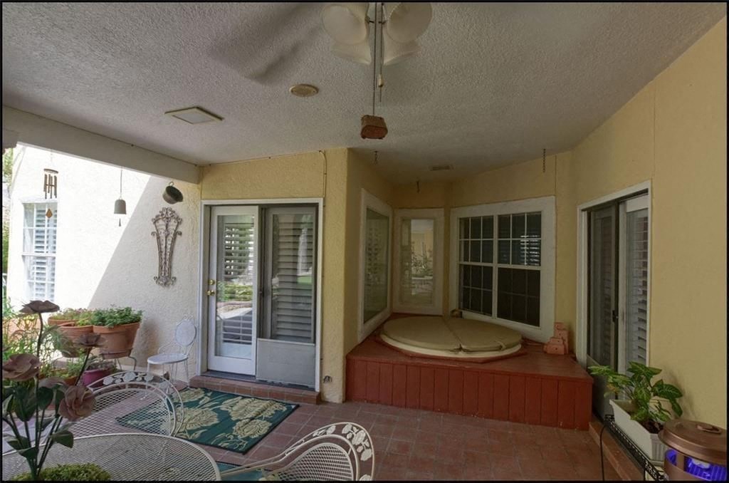a patio with a bed in the center of it