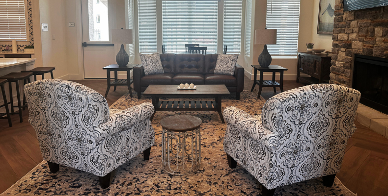 a living room with couches and chairs and a fireplace