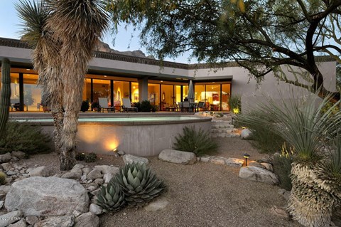 a backyard with a pool and trees and a house