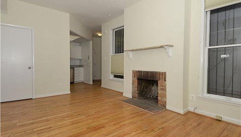 a living room with a fireplace and a wooden floor