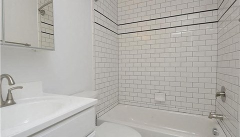 a white bathroom with a sink and a toilet