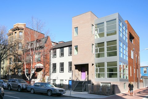 a group of buildings on a city street with cars