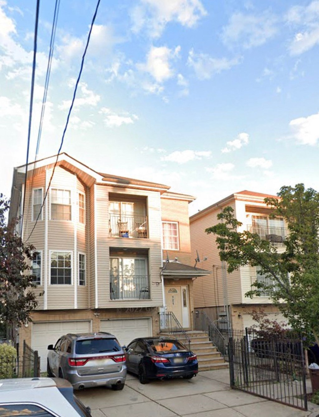 a row of houses with cars parked in front of them