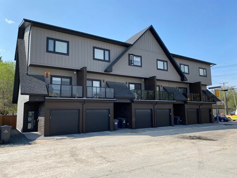 A large two-story house with a garage on the ground floor.