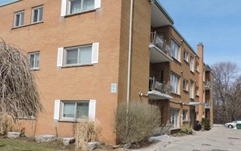 a brick apartment building with a street in front of it