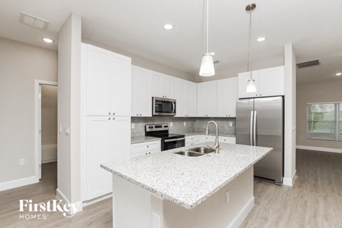 a kitchen with white cabinets and a counter top