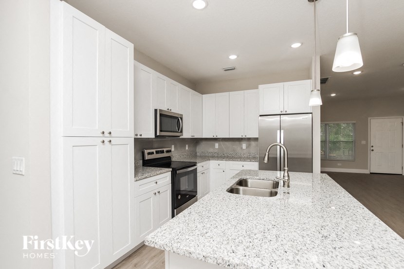 a kitchen with white cabinets and a counter top