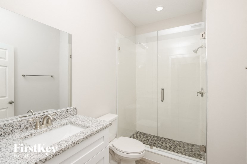 a bathroom with a sink toilet and a shower