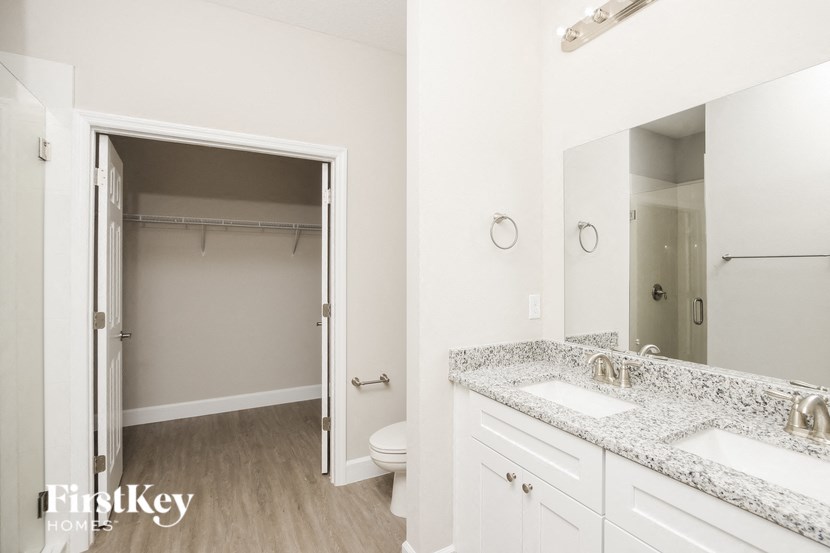 a bathroom with a sink and a mirror and a toilet