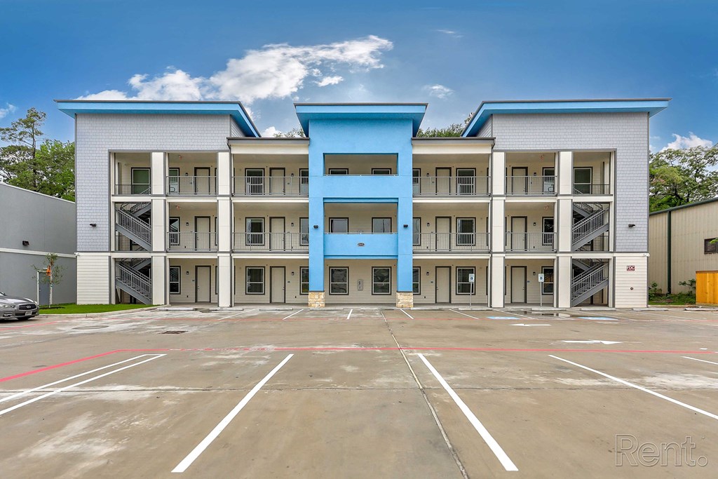 a parking lot in front of an apartment building